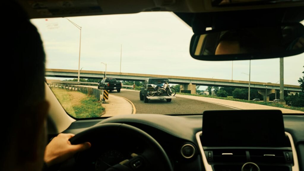 View from a car interior driving on a highway with motorcycles in sight.