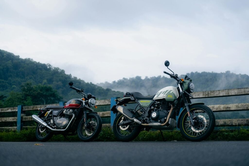 Motorcycles parked against a misty mountain backdrop during a road journey.